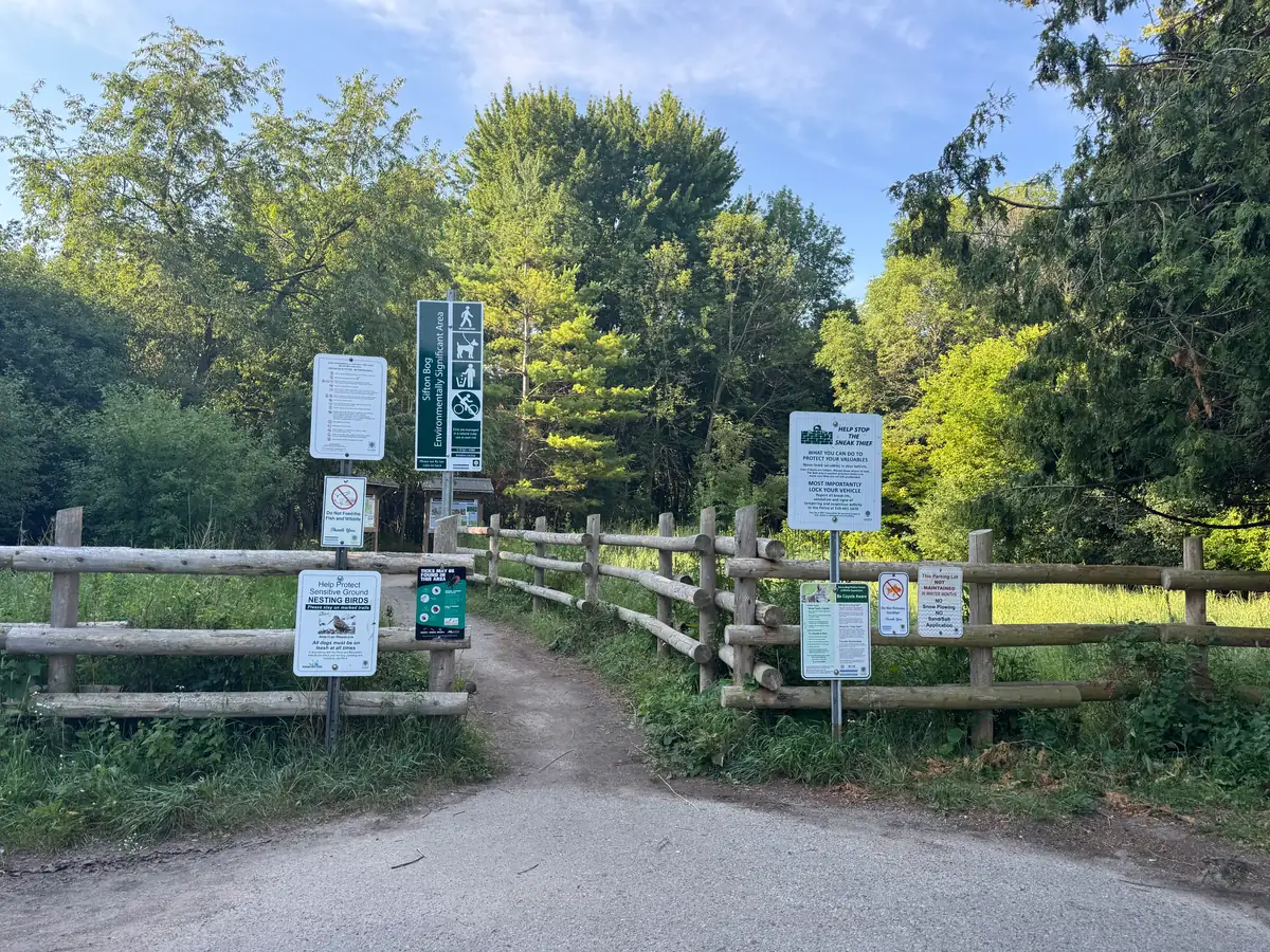 Sifton Bog trail entrance with fencing and interpretive signage, Oakridge, London Ontario