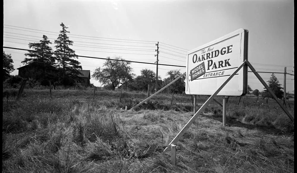 The New Oakridge Park model homes entrance sign standing in an empty field, early 1960s, London Ontario