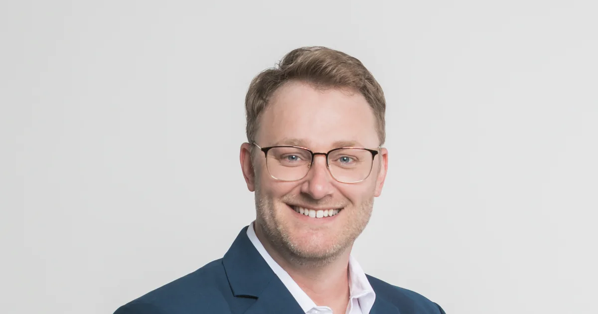 Justin Skrypnyk, London Ontario realtor, standing in a West London neighbourhood